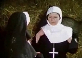 Naughty nun gets licked by a dog on a haystack