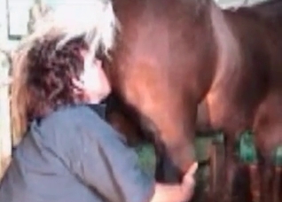 Curly-haired MILF fisting horse pussy